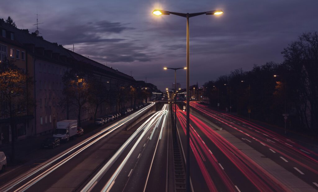 Captivating long exposure of night traffic on a Munich highway with vibrant light trails.